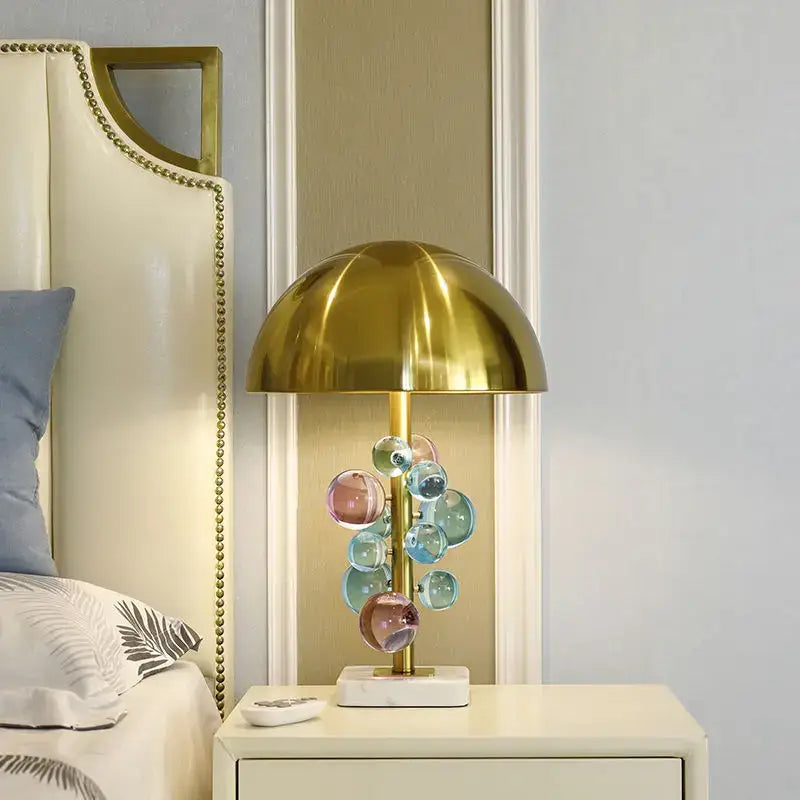 A modern golden mushroom crystal table lamp with a polished gold dome and colorful glass orbs for bedroom decorbites decor