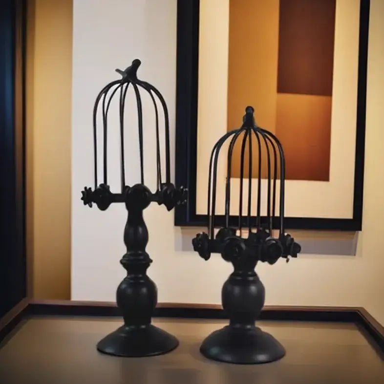 Black wrought iron birdcage style ornament with ornate bases and small birds, golden rose dining room candle holder