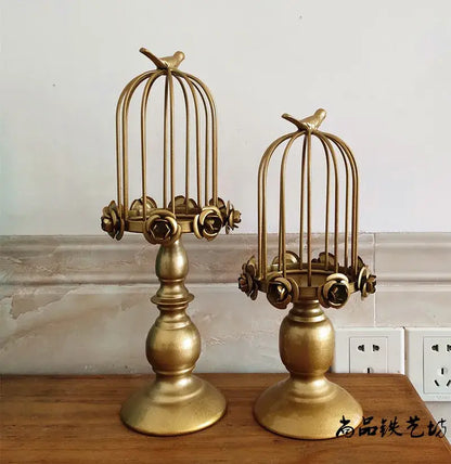 Golden metal birdcage style ornament candle holder with rose embellishments and perched birds for dining room decor