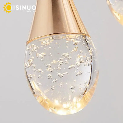 Gold-toned metallic teardrop pendant light with clear glass globe filled with swirling bubbles for decorbites crystal staircase chandelier