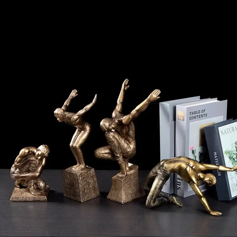 Set of four bronze-finished thinker bodybuilder resin sculptures with dynamic poses for office desk decor