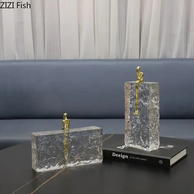 Clear textured glass bookends with small golden figurines for decorbites golden thinker ice crystal living room decor