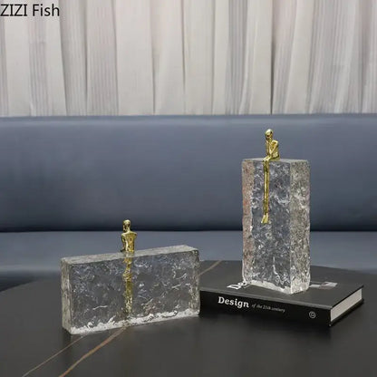 Clear textured glass bookends with small golden figurines for decorbites golden thinker ice crystal living room decor