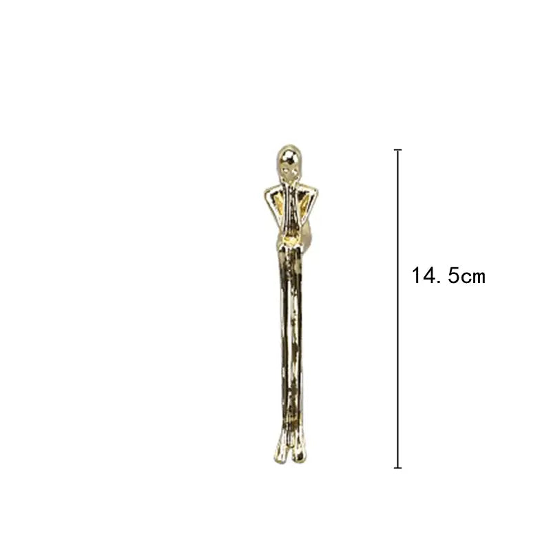 A slender gold-toned thinker ice crystal sculpture with glossy finish and articulated limbs for living room decorbites decor