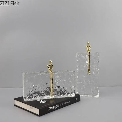 Clear textured glass bookends with gold toned figurine accents for decorbites golden thinker ice crystal decor
