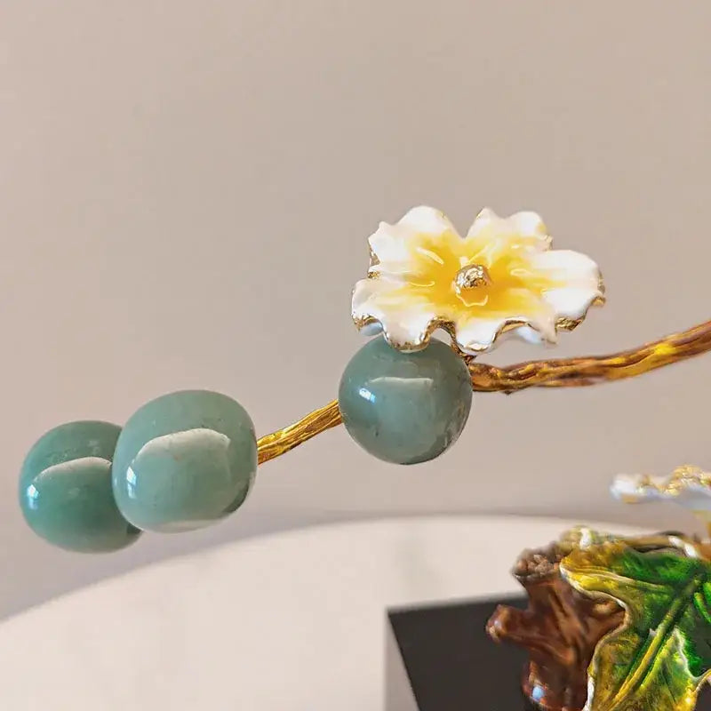 Gold-toned hairpin with white and yellow enamel plum blossom and jade beads inspired by golden tree plum decor