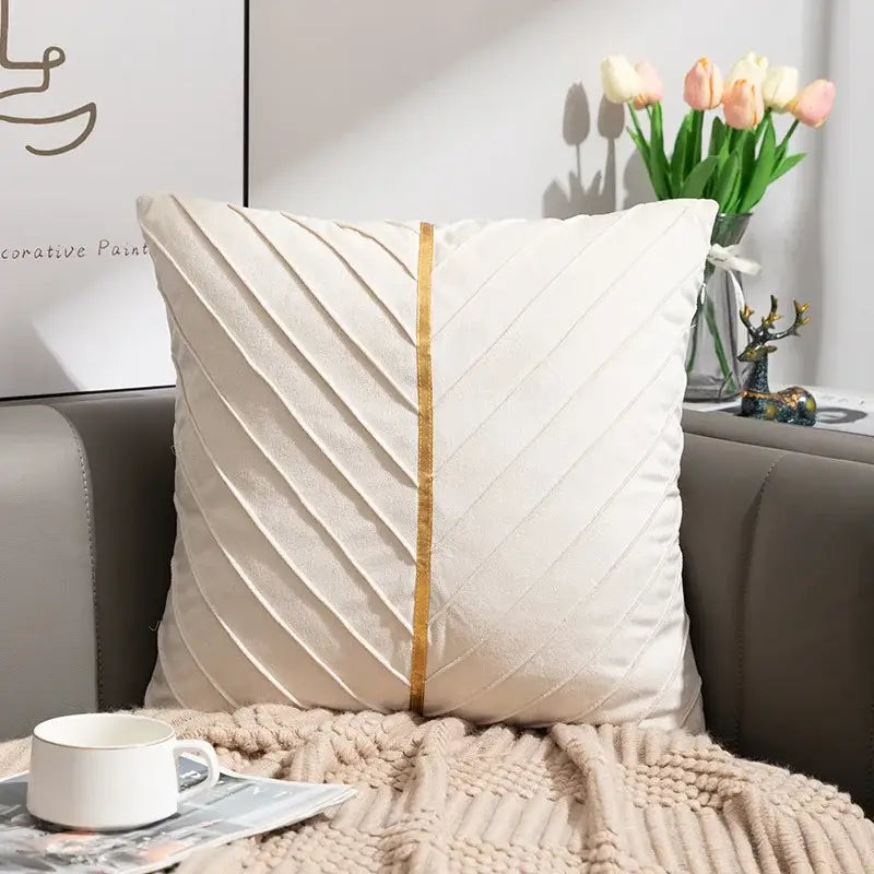 Cream-colored cushion cover with subtle gold vertical stripe and diagonal pleats from decorbites golden velvet patchwork set