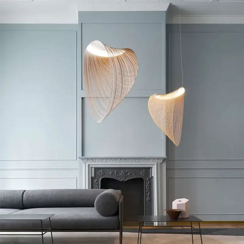 Two warm-toned golden woven nest led pendant chandelier lights with shell-like design for dining room ceiling