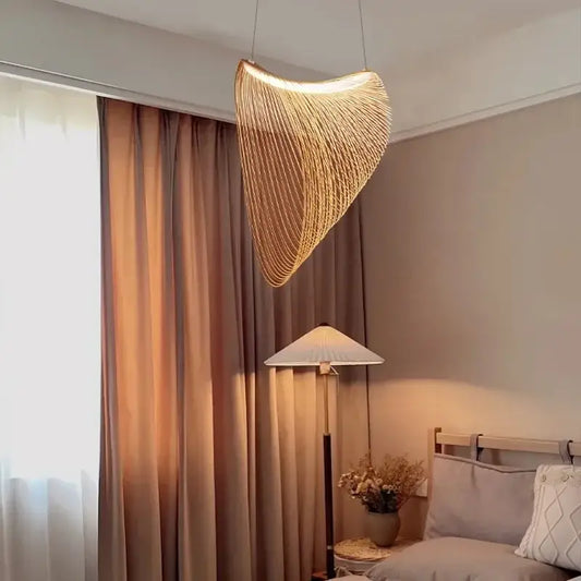 A warm golden woven nest led pendant chandelier with curved design hangs elegantly for dining room lighting