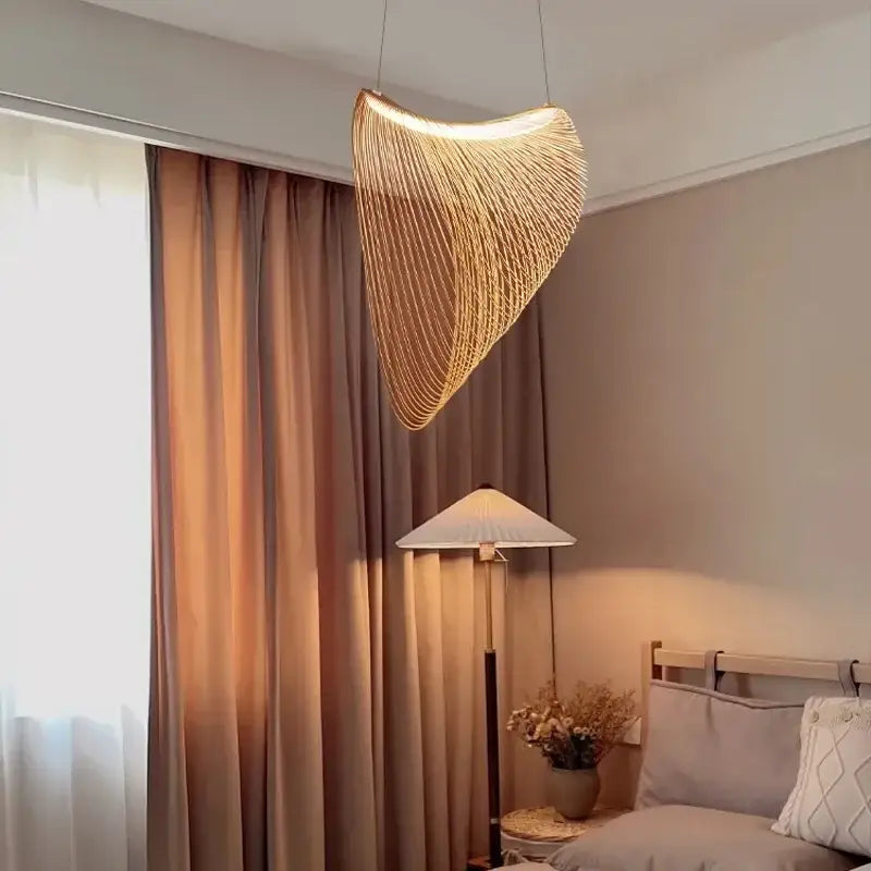 A warm golden woven nest led pendant chandelier with curved design hangs elegantly for dining room lighting
