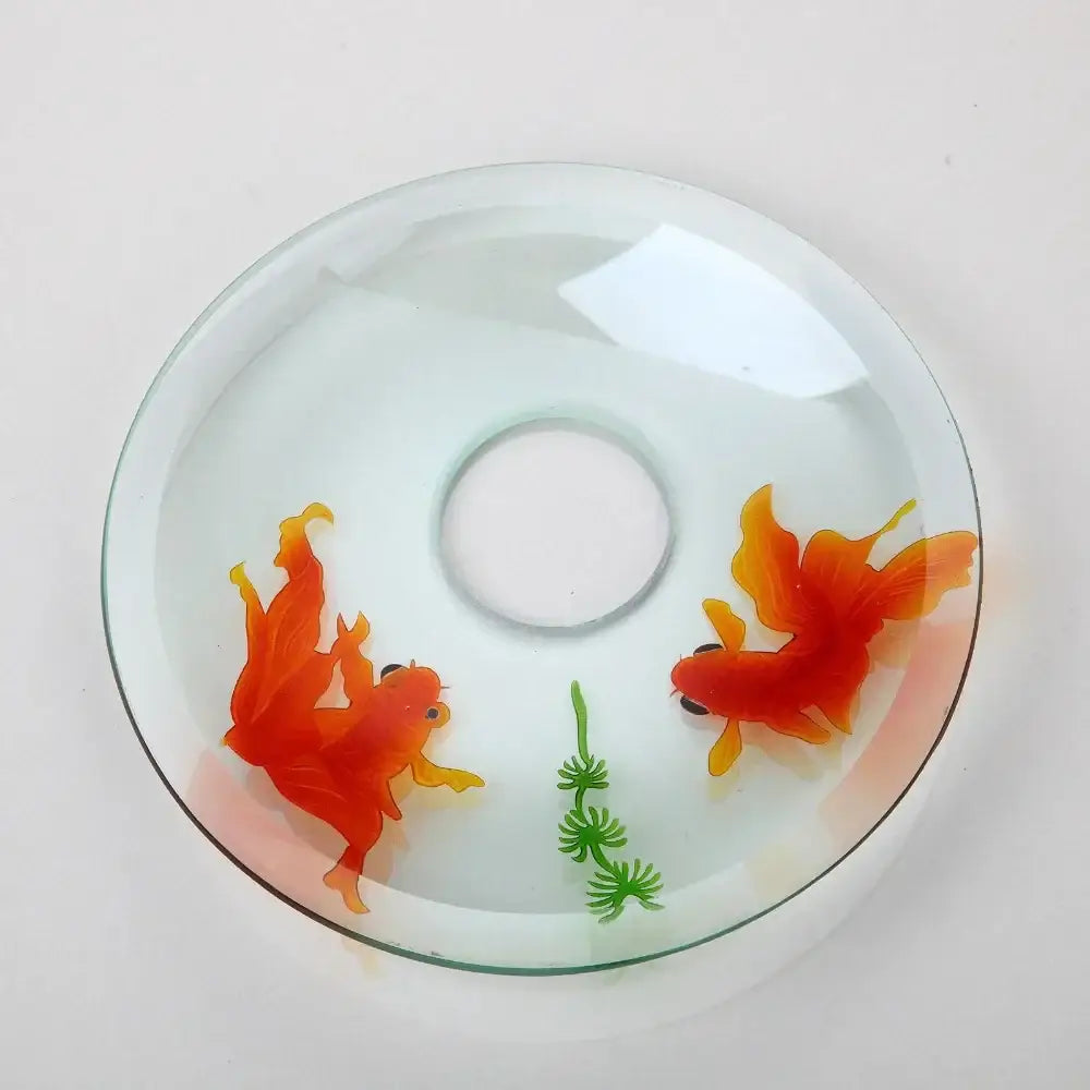 Clear glass cd-style coaster with two vibrant orange goldfish and green plant complements decorbites goldfish glass faucet