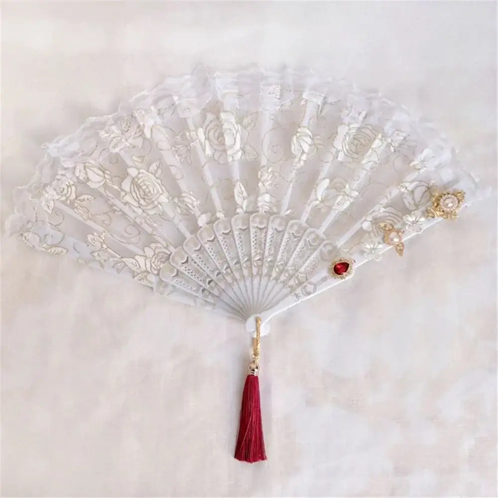 Elegant white lace fan with gold embroidery and red tassel featuring decorbites elegant gemstone handle for party decor