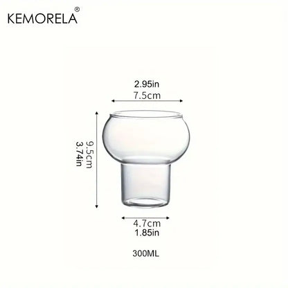 Clear glass cup from gourd shaped glass cup set featuring a rounded bulbous top and short stem with wooden handle