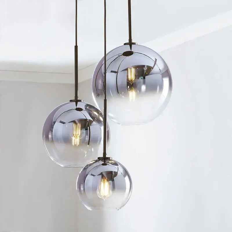 Set of three spherical gradient glass ball pendant lights with frosted and mirrored finish for dining room chandelier