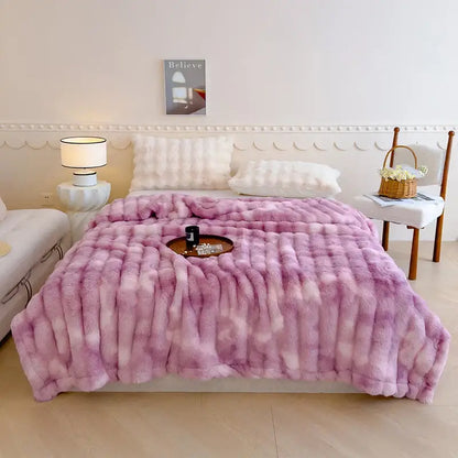 A plush gradient pink faux fur throw blanket with a soft texture paired with decorbites gradient grey cashmere fleece throw