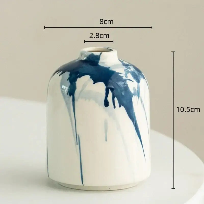 White ceramic vase with blue paint drip design for decorbites graffiti ceramic vase and living room decor