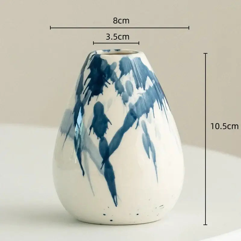 A white ceramic vase with blue brushstroke patterns in a decorbites graffiti ceramic vase for living room decor