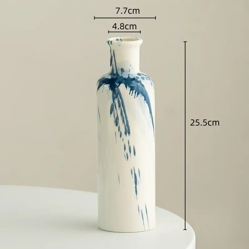 A tall slender white ceramic vase with blue brushstroke patterns for decorbites graffiti ceramic vase living room decor