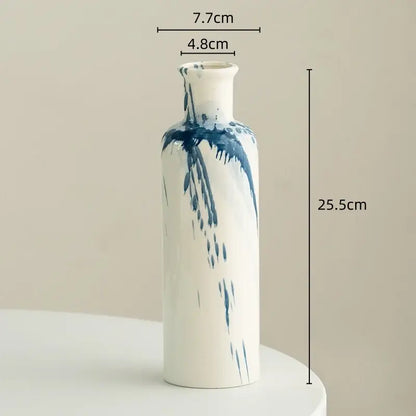 A tall slender white ceramic vase with blue brushstroke patterns for decorbites graffiti ceramic vase living room decor