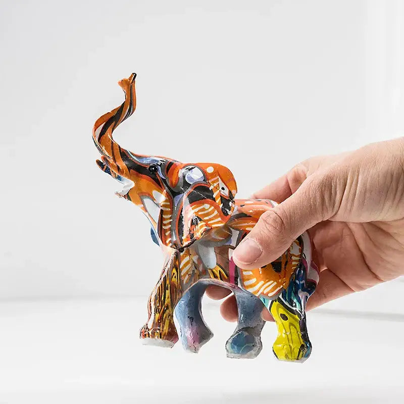 A vibrant graffiti colorful elephant resin figurine with bold orange and black trunk for living room decorbites elephant resin