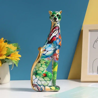 A vibrant mosaic-patterned ceramic cat figurine with a glossy finish and gold-tipped tail for decorbites leopard resin decor