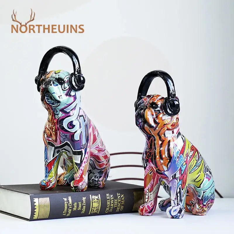 Two vibrant graffiti resin bulldog headphone figurines wearing black headphones for living room decor