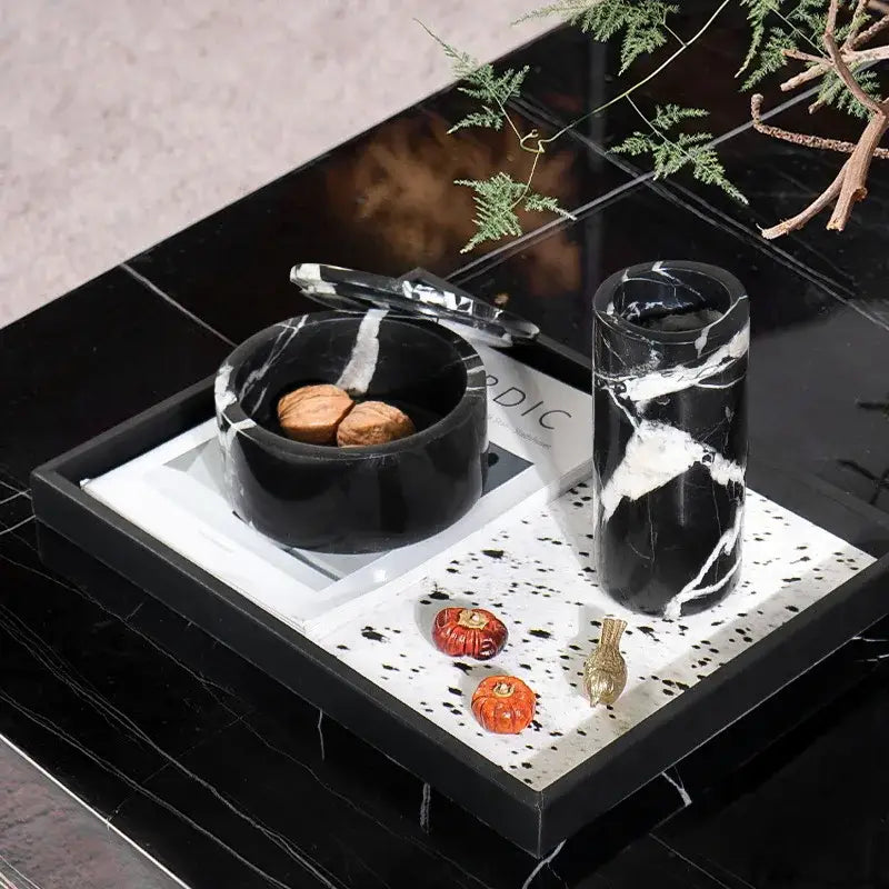 Black marble serving tray with white veining featuring matching grand antique storage jar and nut bowl decorbites grand antique