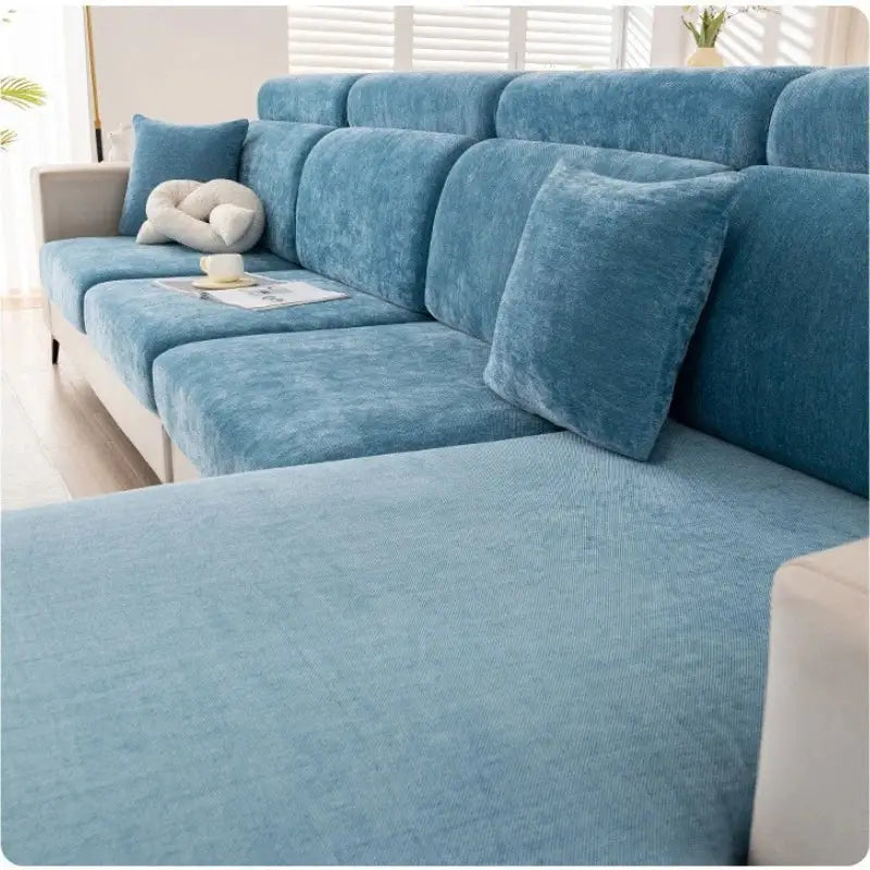 Blue velvet sofa cover with matching cushions designed as a universal living room slipcover in chenille fabric