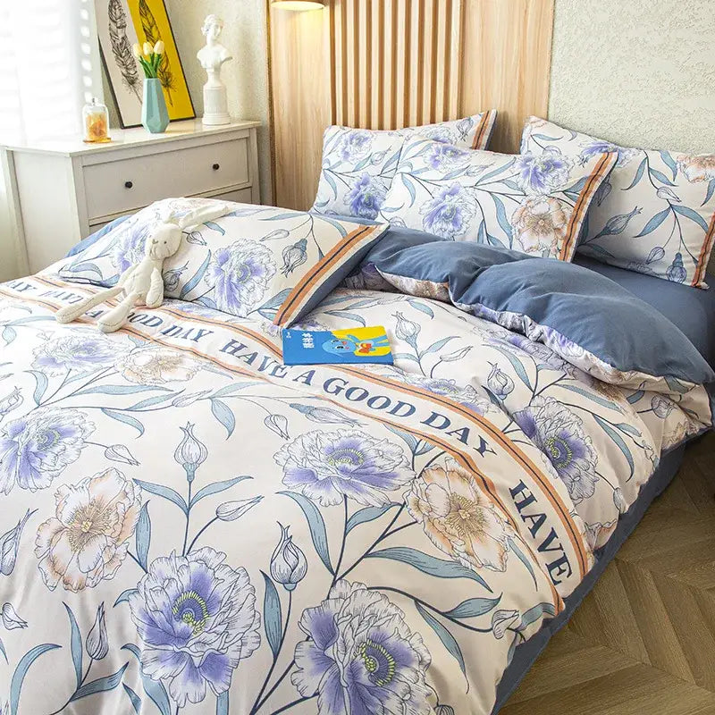 Gray and mustard floral green leaf print bedding set with purple and blue blossoms on cream background with navy edges