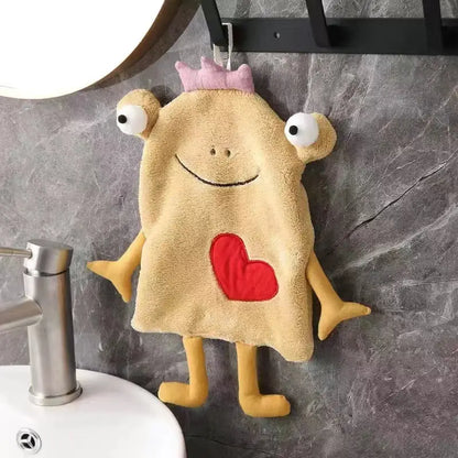 A plush tan hand towel shaped like a cartoon monster with embroidered eyes and red heart for decorbites frog design decor