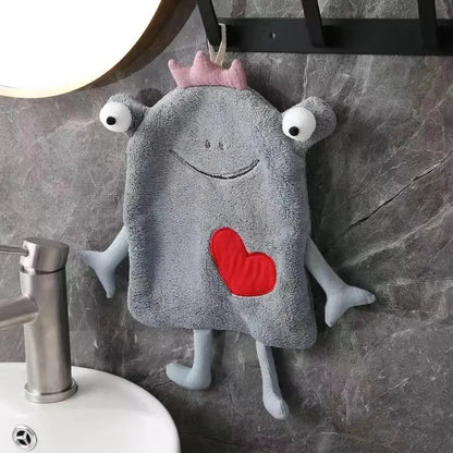 Gray plush hand towel with frog design features a pink crown white embroidered eyes and red heart patch decorbites frog design