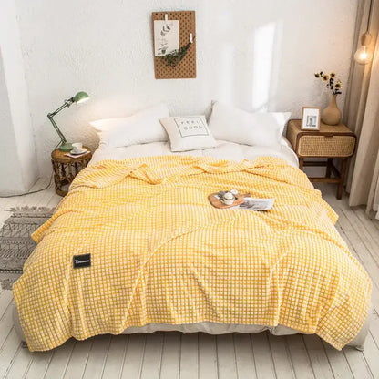 Yellow checkered fleece bed blanket featuring gray plaid coral design for cozy bedroom use