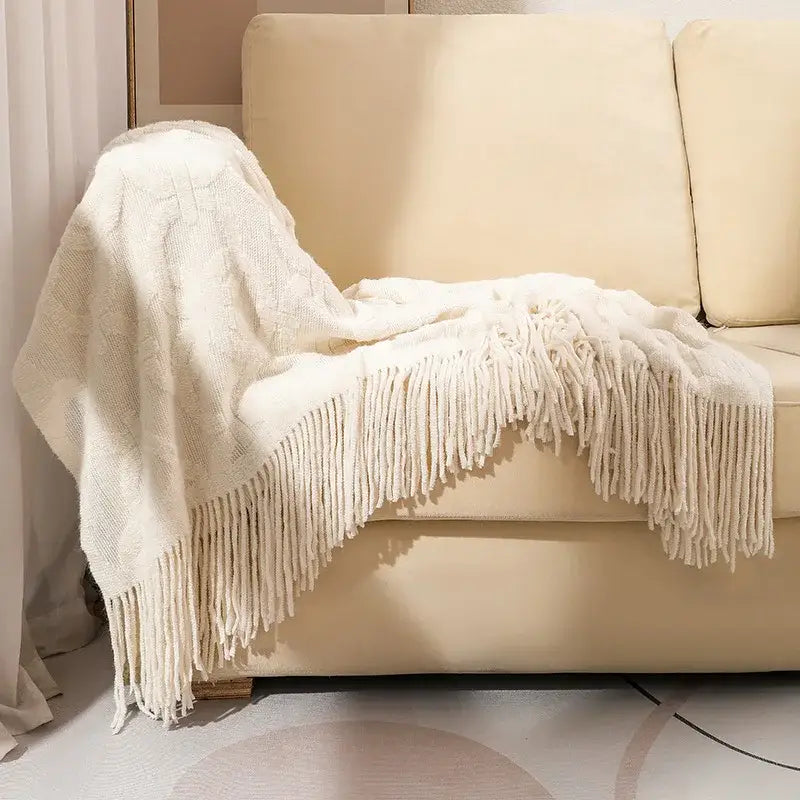 Cream-colored knit blanket with fringe detailing ideal as a decorbites knit blanket sofa throw for living room decor