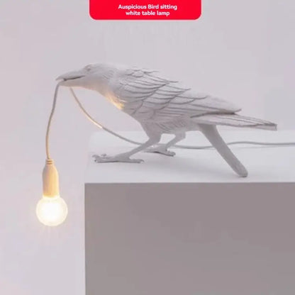 Gray ceramic lively bird resin table lamp with white ceramic bird holding glowing bulb in beak for bedroom decorbites lively bird