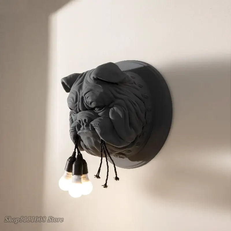 Dark gray decorbites bulldog resin wall lamp with three exposed bulbs hanging from mouth for bedroom decor