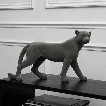 Gray concrete leopard flocking sculpture with textured spotted surface and sleek lifelike posture for living room decor