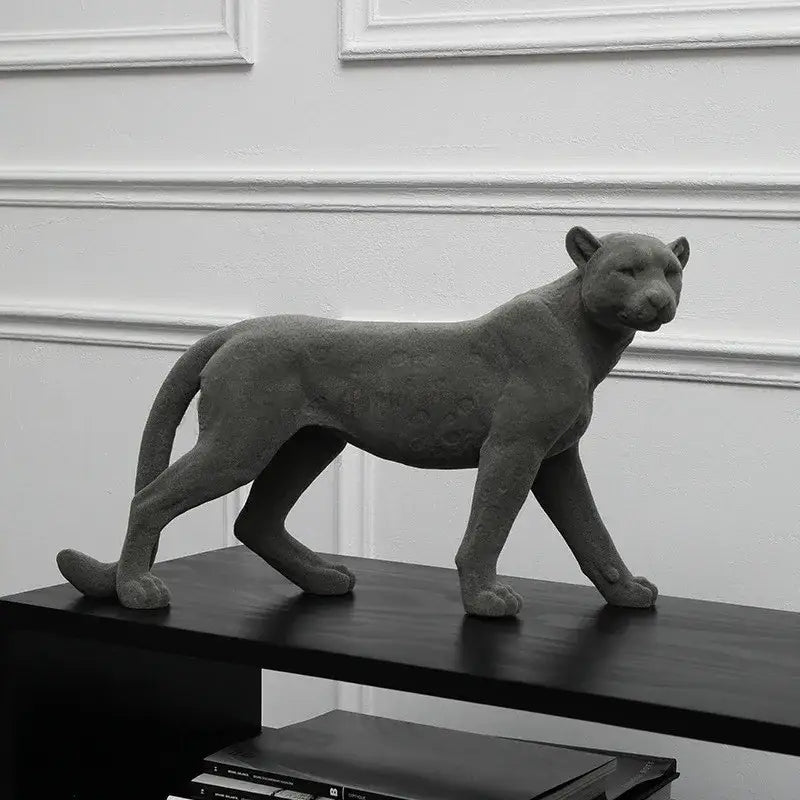 Gray concrete leopard flocking sculpture with textured spotted surface and sleek lifelike posture for living room decor