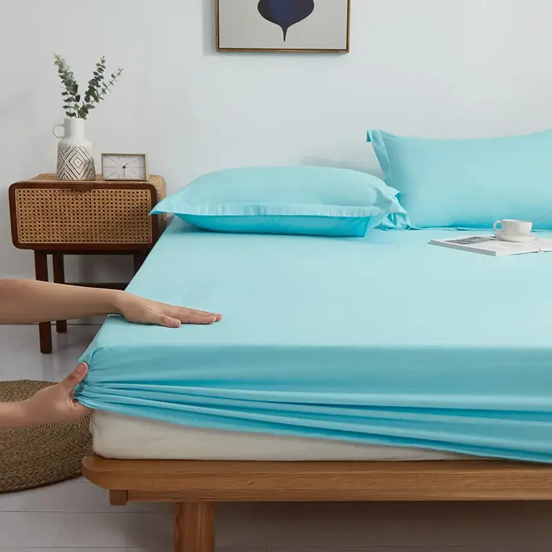 Light blue decorbites cotton fitted sheet set with smooth finish and elastic edge stretched over mattress