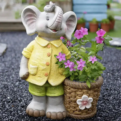 A gray ceramic elephant garden decoration wearing a yellow jacket and green shorts holding a woven flower basket planter