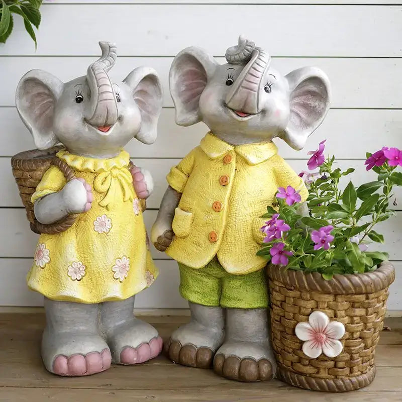 A charming pair of gray floral ceramic elephant garden decoration statues with colorful clothing and accessories