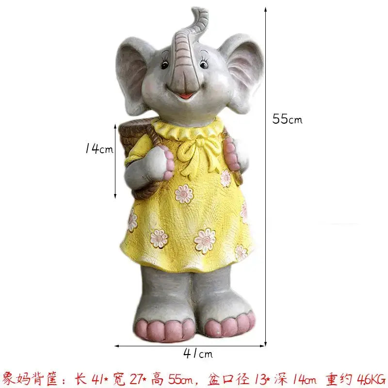 A gray ceramic elephant garden decoration wearing a yellow floral dress and carrying a woven basket outdoors