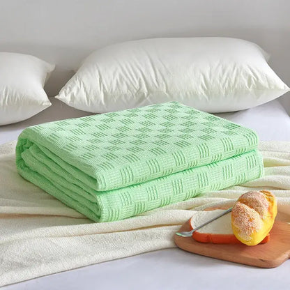 Gray herringbone cotton waffle towel quilt featuring a soft light green woven diamond pattern for bedroom or office decorbites cotton waffle