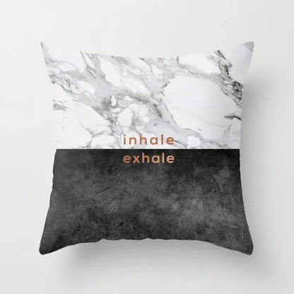 A square pillow case with gray marble top half, black agate bottom, copper inhale exhale text for living room decor