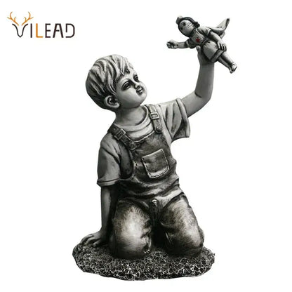 Gray resin super nurse angel boy statue kneeling in overalls holding a doll for living room decor