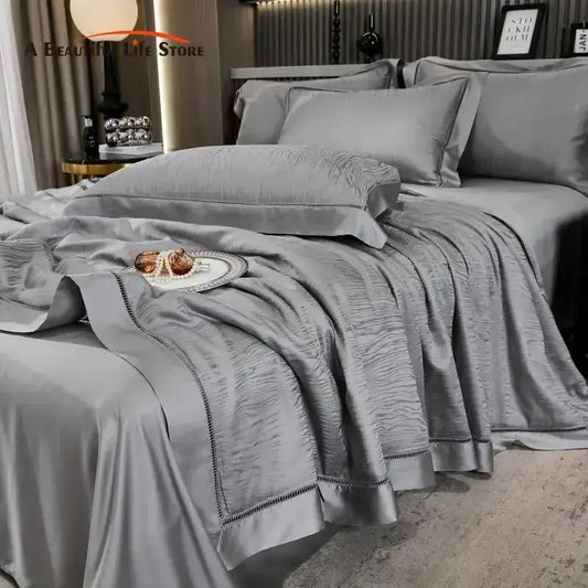 Gray ruched summer quilt set with satin-like texture and elegant black embroidered trim for bedroom bedding
