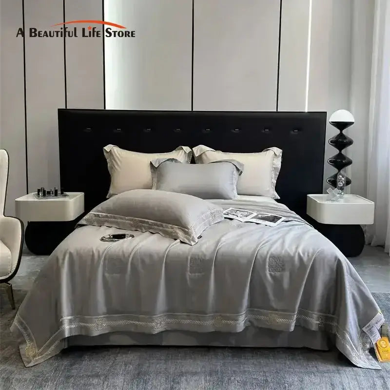 Gray satin eucalyptus fiber summer quilt bedding set with delicate gold embroidery trim for elegant bedroom decorbites