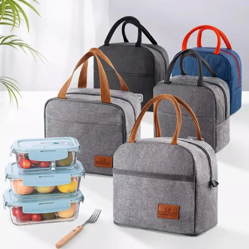 Gray textured insulated lunch bag with brown leather handles and matching rectangular brand patch for kitchen use