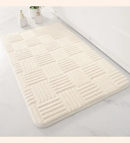 Cream-colored bath mat with textured raised grid pattern suitable as a non slip striped floor mat for bathroom use