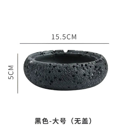Gray volcanic stone cement astronaut ashtray in black lava rock with porous texture 15.5cm wide and 5cm high