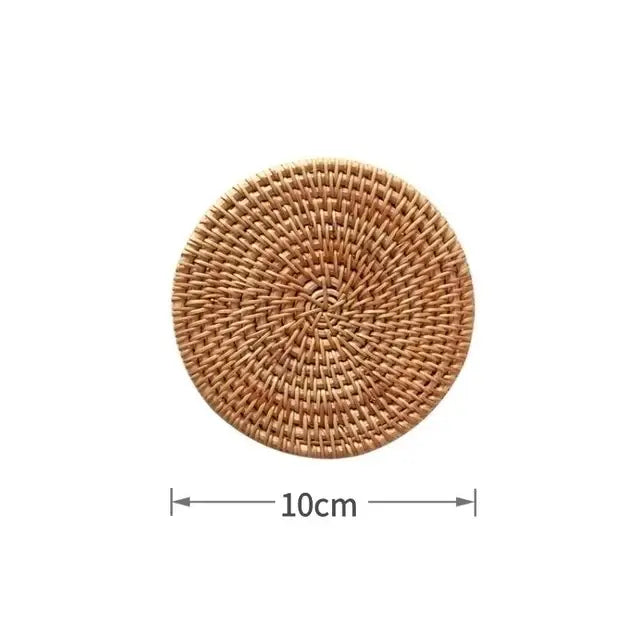 A round 10cm diameter woven rattan coaster with natural tan color complements decorbites 450ml striped glass cup